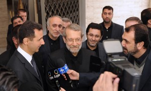 Syria's President Bashar al-Assad and Iran's Parliament speaker Ali Larijani speak to the media after meeting in Damascus