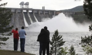People watch shutters of the spillway open at the Krasnoyarsk hydroelectric power station near the town of Divnogorsk