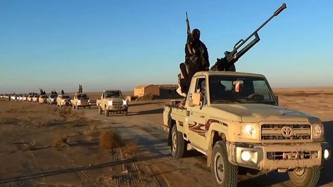 The photo posted on June 9, 2014 on a terrorist website shows ISIL militants driving at an undisclosed location in Iraq's Nineveh Province.