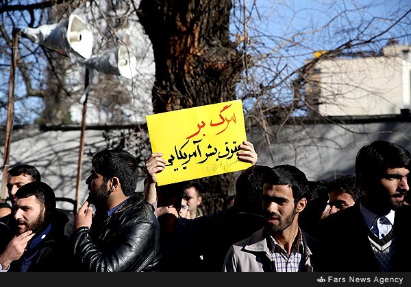 Iranian students shout slogans during a demonstration on February 18, 2015, near the Swiss embassy in Tehran, in solidarity with the three Muslim American students murdered last week in the North Carolina university town of Chapel Hill