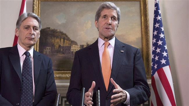 US Secretary of State John Kerry (R) and British Foreign Secretary Philip Hammond address a joint press conference in London on February 21, 2015.