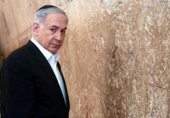 Israel's Prime Minister Benjamin Netanyahu stands next to the Western Wall, Judaism's holiest prayer site, during a visit in Jerusalem's Old City February 28, 2015.