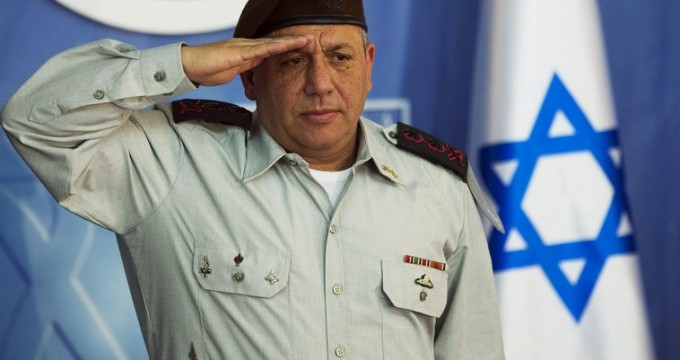 The new Israeli Chief of Staff Lieutenant-General Eizenkot salutes during a handover ceremony in Jerusalem
