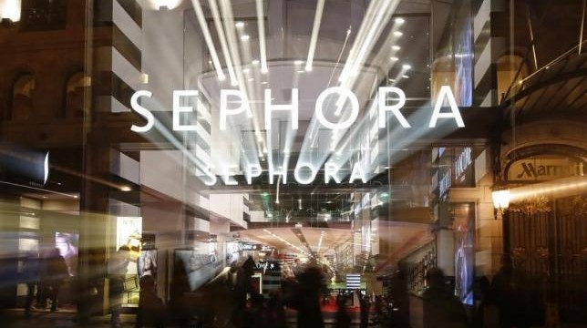 People walk out of the Sephora store on the Champs Elysees Avenue in Paris