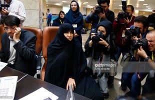 Iranian Esmat Savadi (2nd L) registers her candidacy for the Assembly of Experts elections
