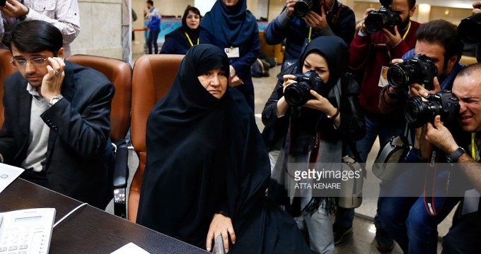 Iranian Esmat Savadi (2nd L) registers her candidacy for the Assembly of Experts elections